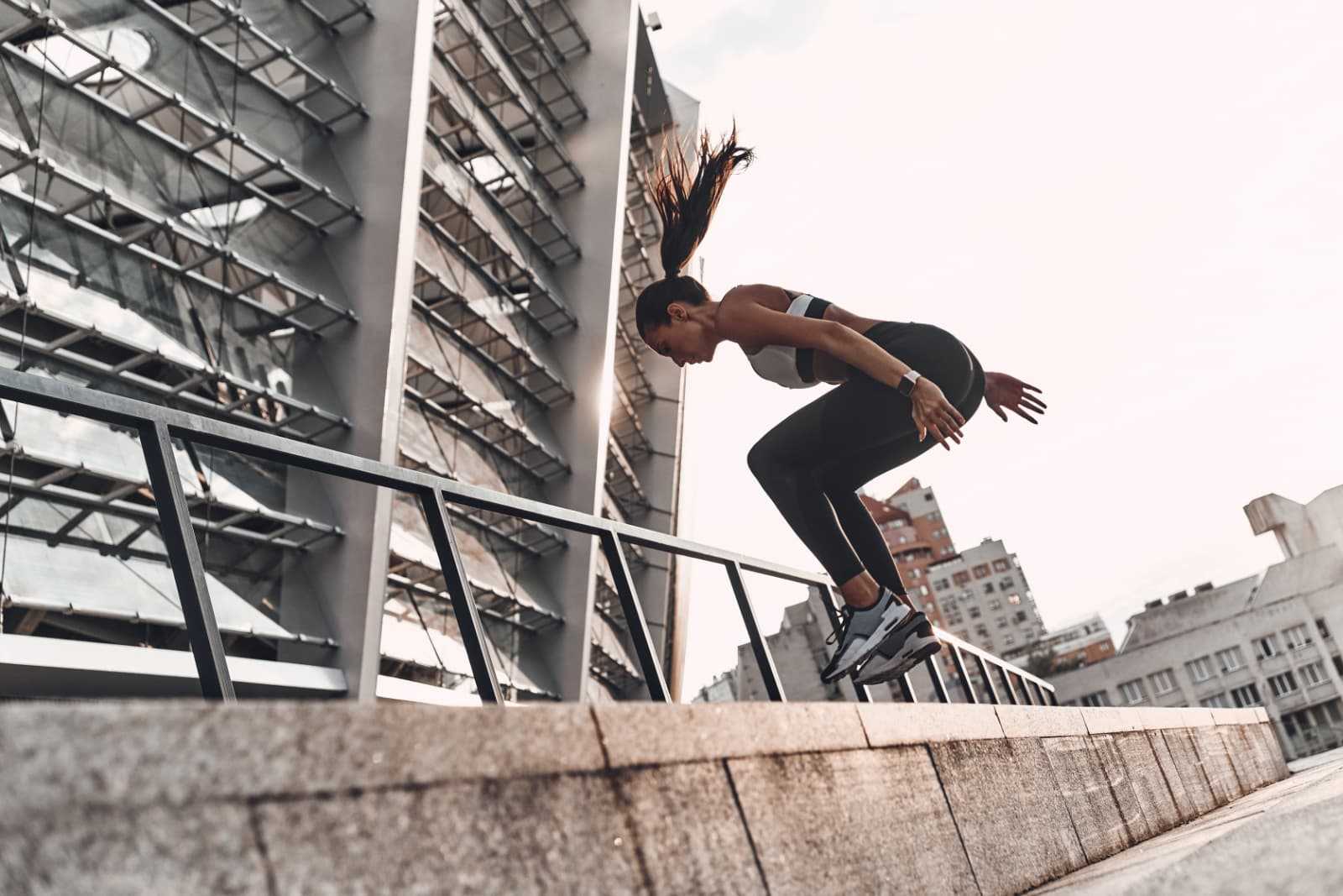 Woman jumping in an urban setting